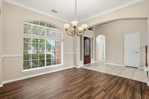 a view of a livingroom with wooden floor and a ceiling fan