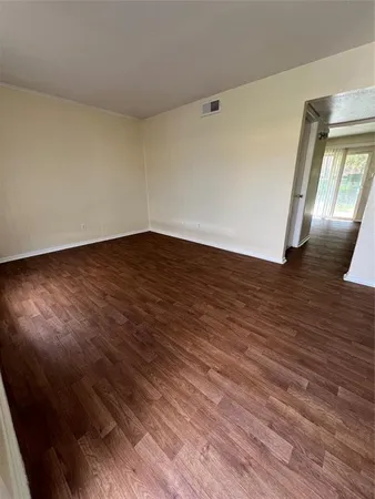 a view of wooden floor and windows in a room