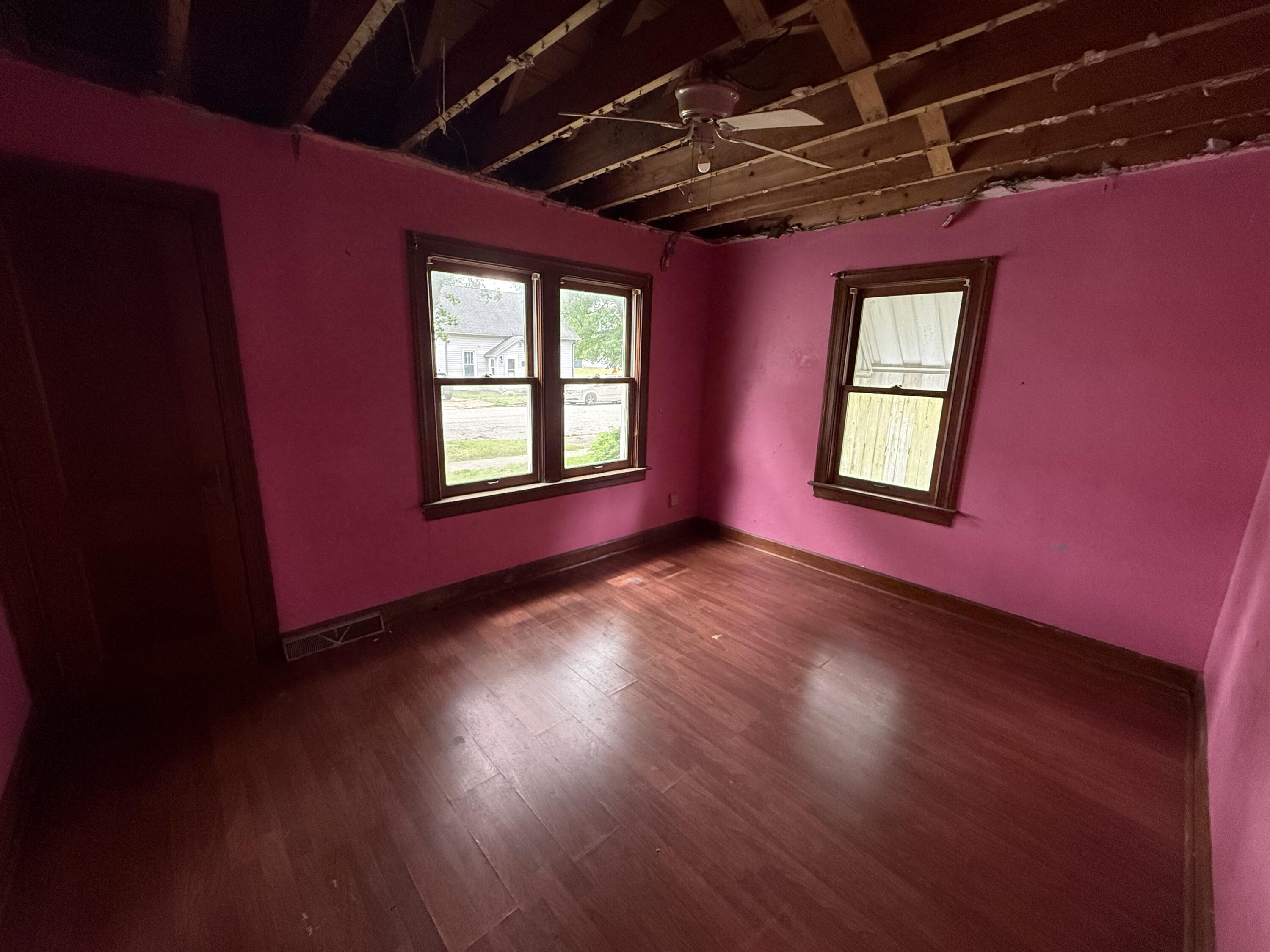 118 West Spring Street Winamac, IN 46996 - Photo 7 of 11 a view of an empty room with wooden floor and windows