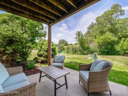 a patio with garden and furniture
