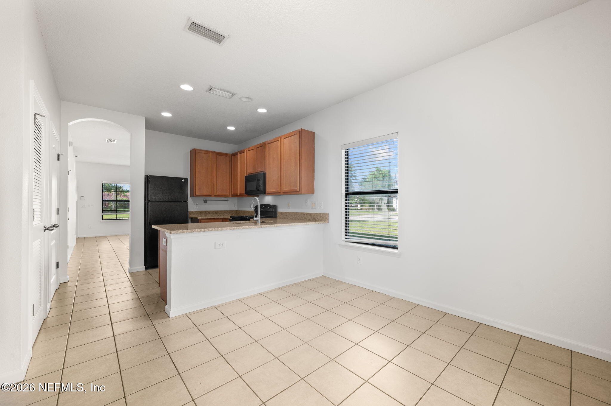 253 Syrah Way St. Augustine, FL 32084 - Photo 14 of 39 a kitchen with white cabinets and appliances