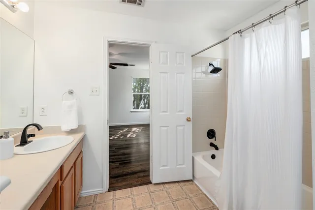 a bathroom with a sink a mirror and shower