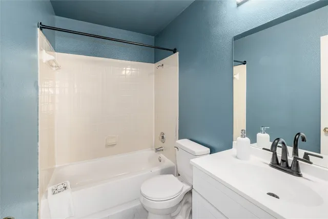 a bathroom with a sink a toilet and a bathtub