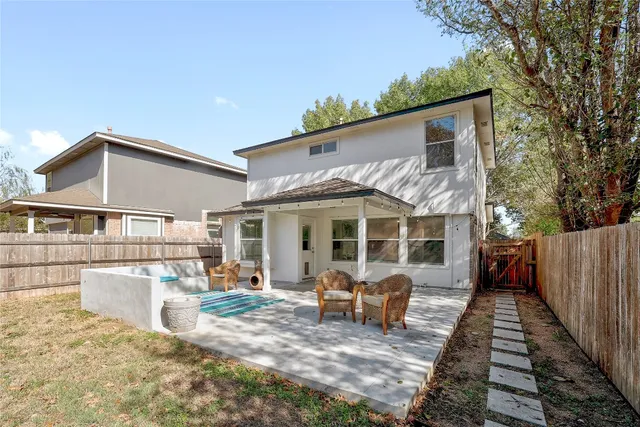 a view of a house with wooden deck and furniture