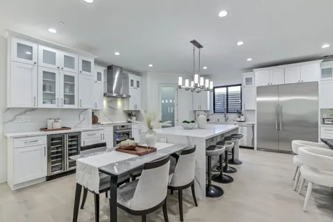 a large kitchen with a table and chairs in it