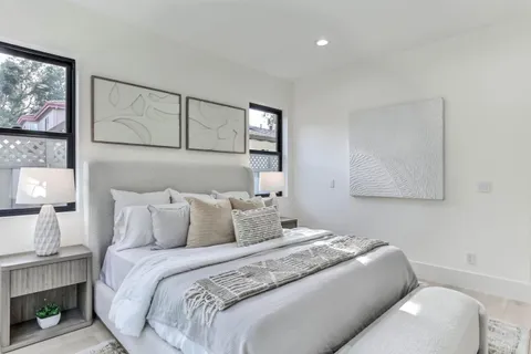 a bedroom with a bed and a painting on the wall