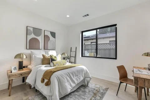 a bedroom with a bed and a chair