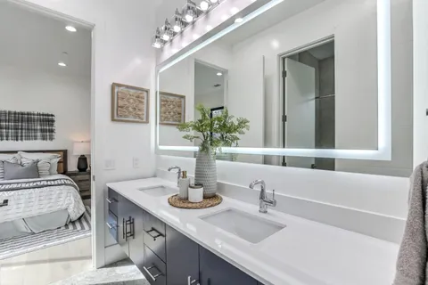 a bathroom with a sink double vanity and a mirror