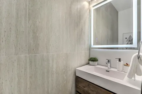 a bathroom with a sink a mirror and a shower curtain