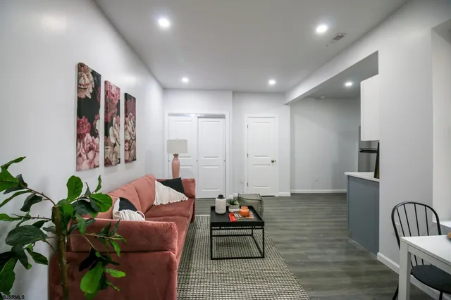 a kitchen with a refrigerator a sink and dishwasher with wooden floor
