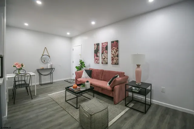 a open kitchen with stainless steel appliances granite countertop a refrigerator and a stove top oven