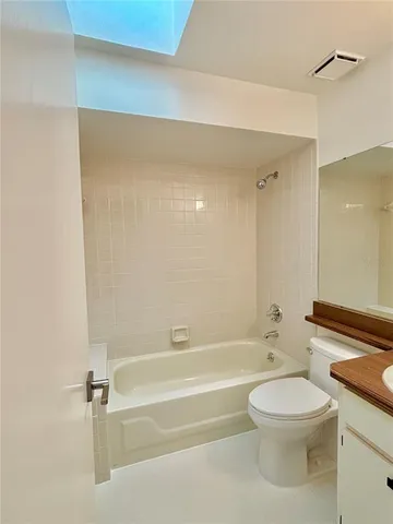 a bathroom with a toilet a sink and bathtub