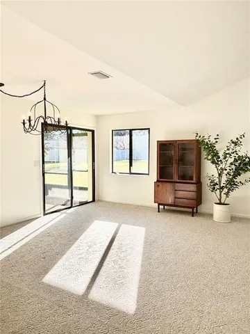 a view of a livingroom with furniture and a flat screen tv