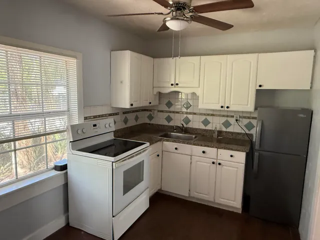 a kitchen with a white cabinets and white appliances