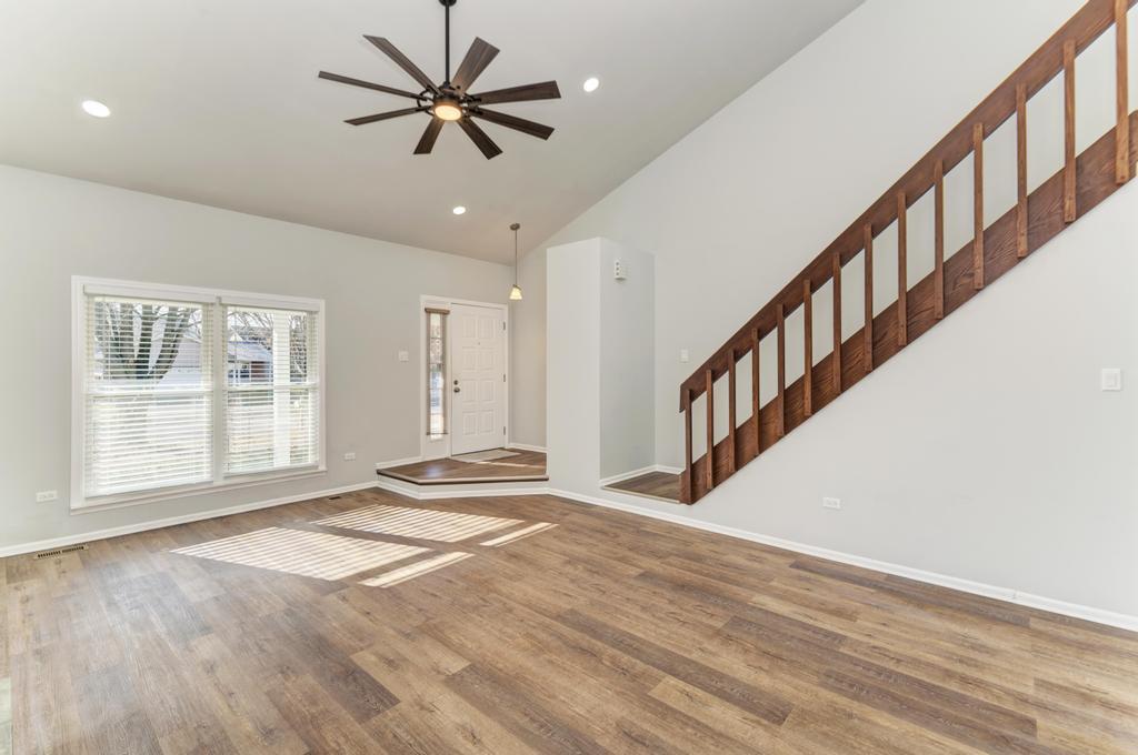 381 Pearson Circle Naperville, IL 60563 - Photo 34 of 43 a view of an empty room with a window and wooden floor