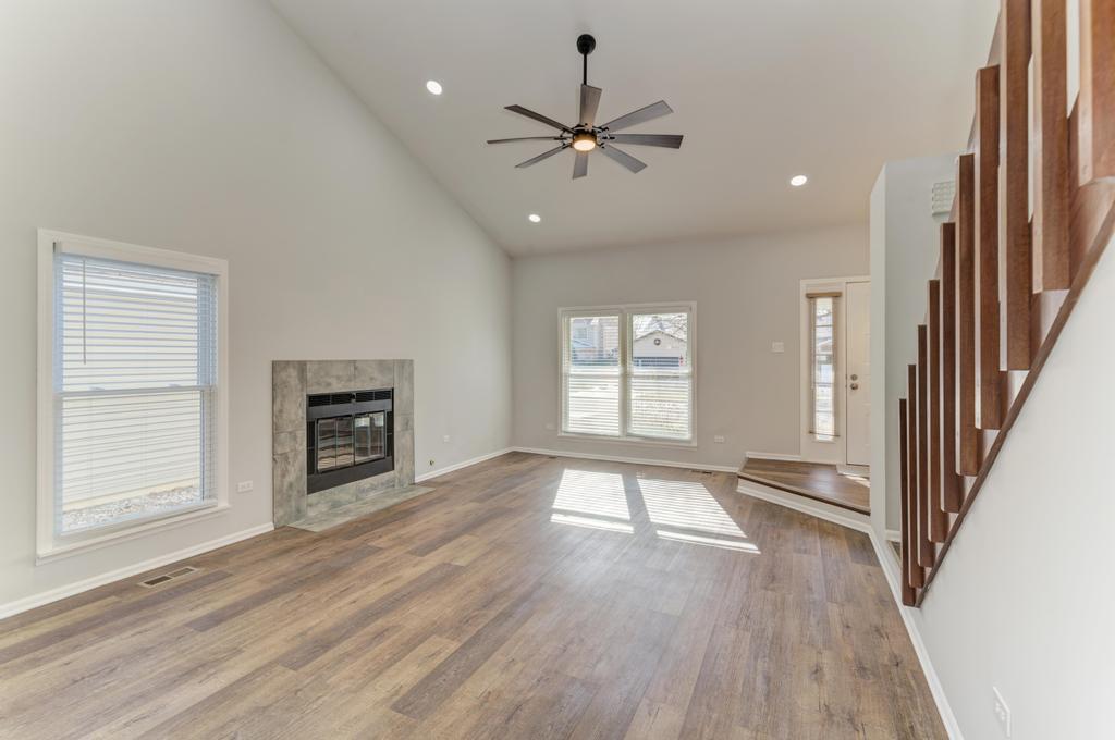 381 Pearson Circle Naperville, IL 60563 - Photo 35 of 43 an empty room with wooden floor fan and windows
