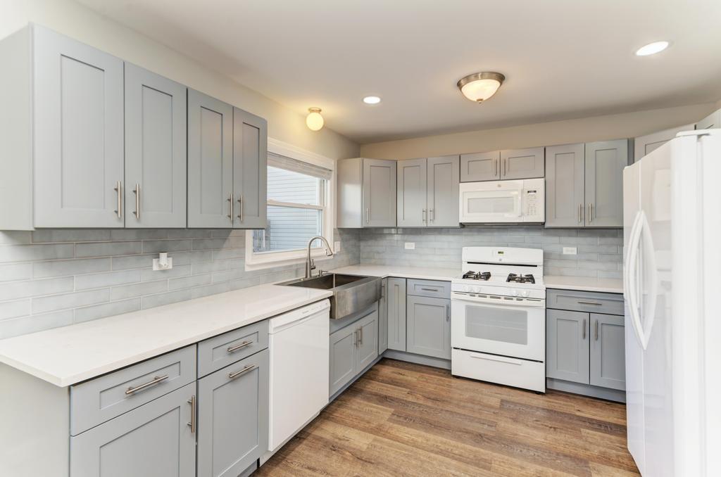 381 Pearson Circle Naperville, IL 60563 - Photo 4 of 43 a kitchen with a white cabinets and white appliances