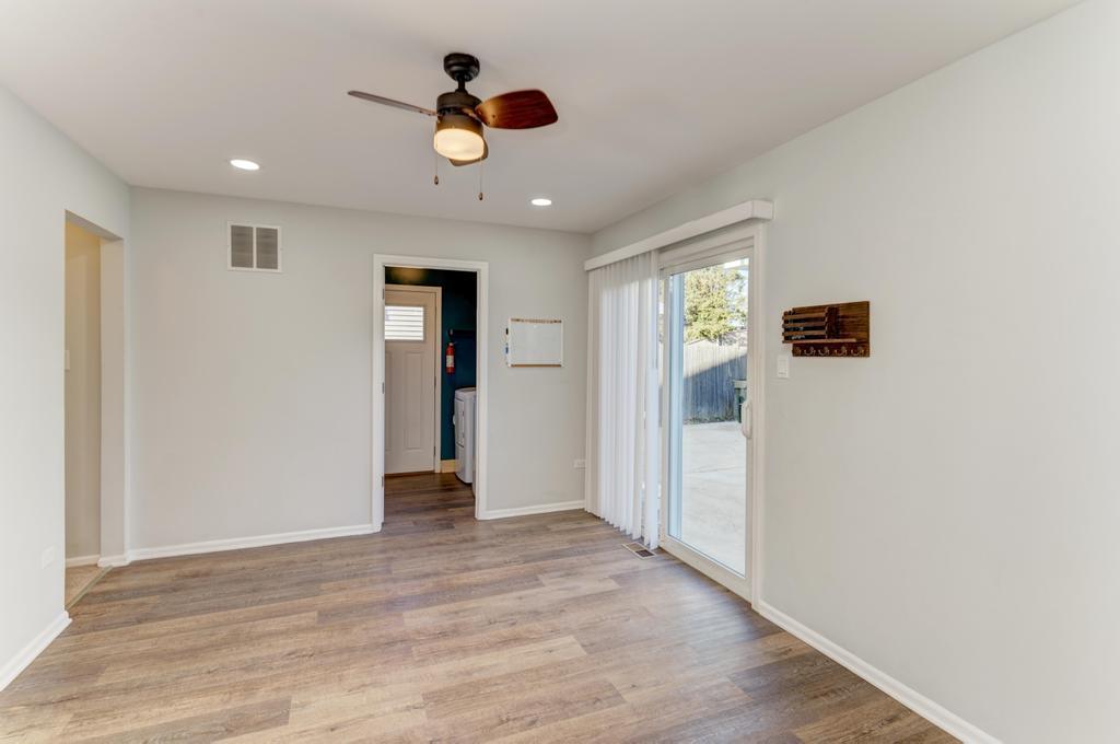 381 Pearson Circle Naperville, IL 60563 - Photo 7 of 43 a view of an empty room with wooden floor and windows
