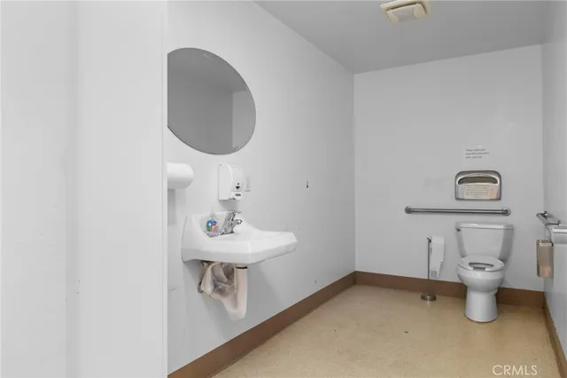a bathroom with a sink toilet and a mirror