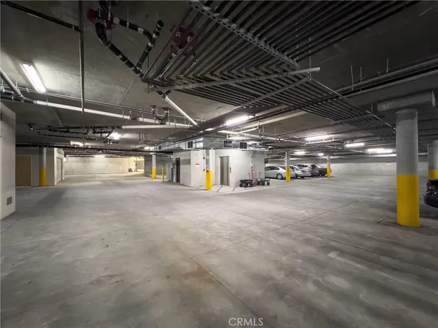 a view of parking garage with lots of traffic