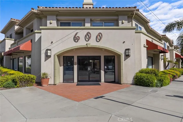 a front view of a building with garden