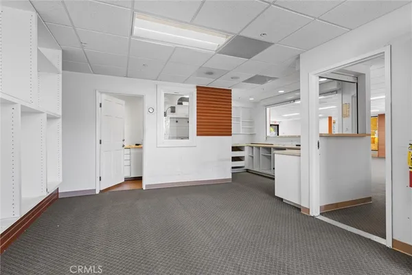 a view of a kitchen with a sink and a refrigerator