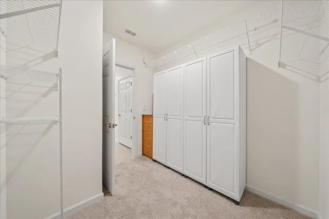 a view of a workspace with furniture and a potted plant