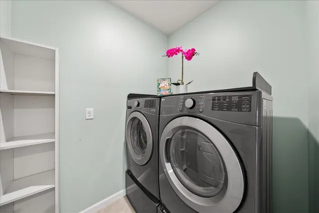 an empty room with a ceiling fan and window