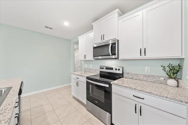 a en suite bathroom with a granite countertop sink and a mirror