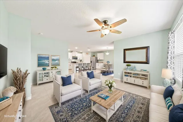 a view of a livingroom with furniture and a ceiling fan