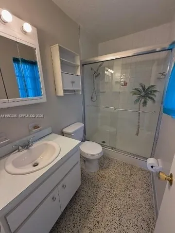 a bathroom with a sink toilet and shower