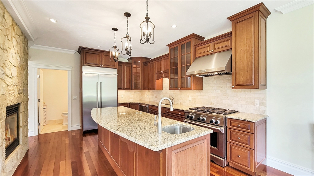 4 Quinns Way, Unit 4 Mashpee, MA 02649 - Photo 11 of 29 a kitchen with stainless steel appliances granite countertop a sink a stove and a wooden floors