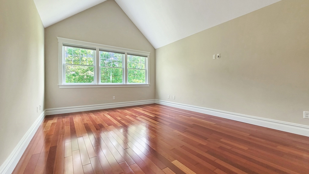 4 Quinns Way, Unit 4 Mashpee, MA 02649 - Photo 18 of 29 an empty room with wooden floor and windows