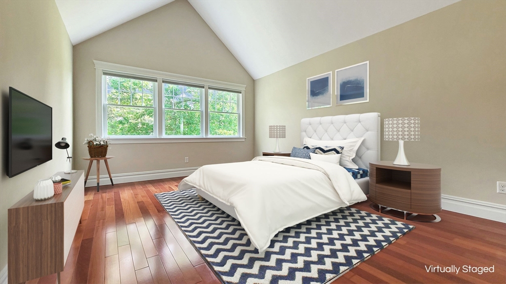 4 Quinns Way, Unit 4 Mashpee, MA 02649 - Photo 19 of 29 a bedroom with a bed and a flat screen tv