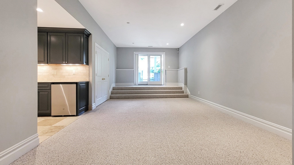 4 Quinns Way, Unit 4 Mashpee, MA 02649 - Photo 22 of 29 an empty room with wooden floor and windows