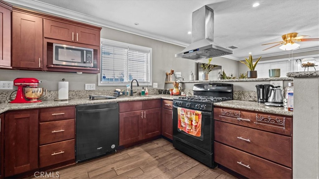 8715 Lurline Street Rancho Cucamonga, CA 91701 - Photo 11 of 41 a kitchen with stainless steel appliances granite countertop a sink and wooden cabinets