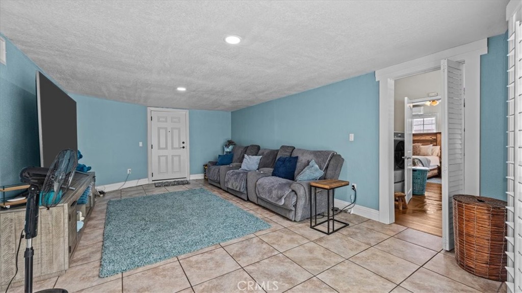 8715 Lurline Street Rancho Cucamonga, CA 91701 - Photo 20 of 41 a living room with furniture and a flat screen tv