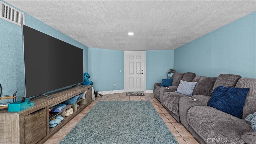 8715 Lurline Street Rancho Cucamonga, CA 91701 - Photo 21 of 41 a living room with furniture and a flat screen tv