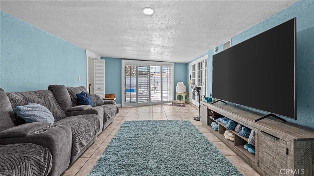 8715 Lurline Street Rancho Cucamonga, CA 91701 - Photo 22 of 41 a living room with furniture and a flat screen tv