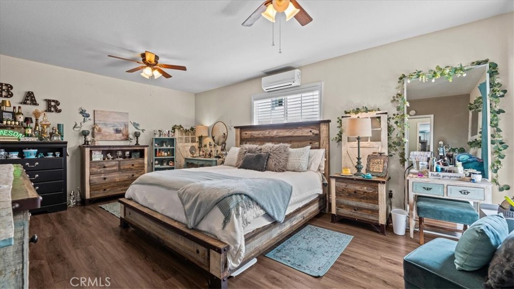 8715 Lurline Street Rancho Cucamonga, CA 91701 - Photo 24 of 41 a bedroom with a bed and wooden floor