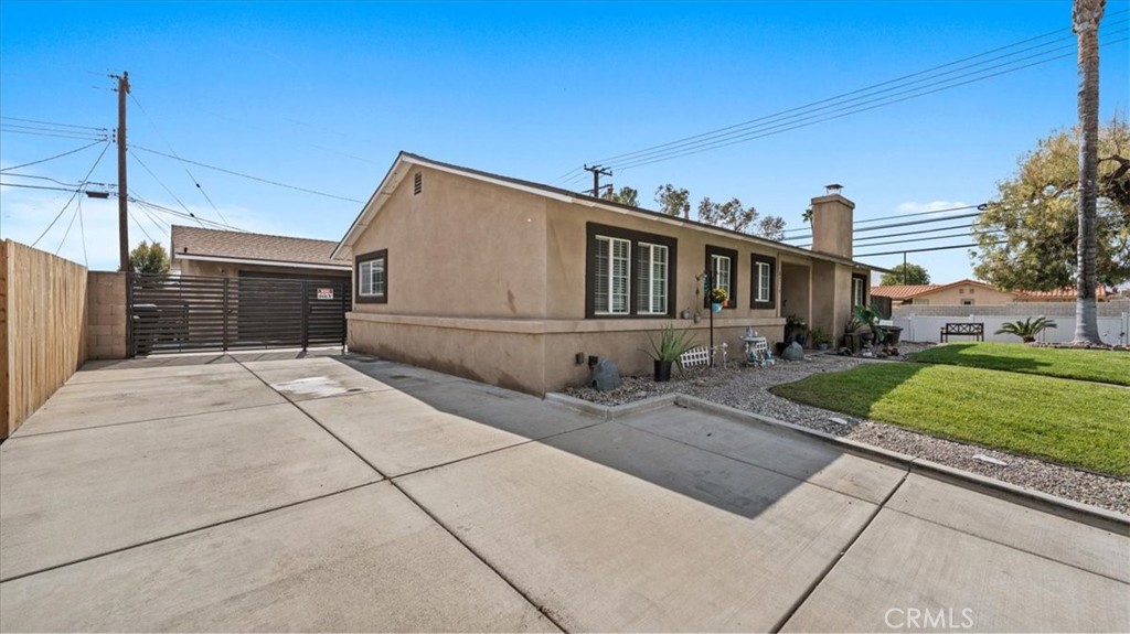 8715 Lurline Street Rancho Cucamonga, CA 91701 - Photo 3 of 41 a front view of a house with a garden