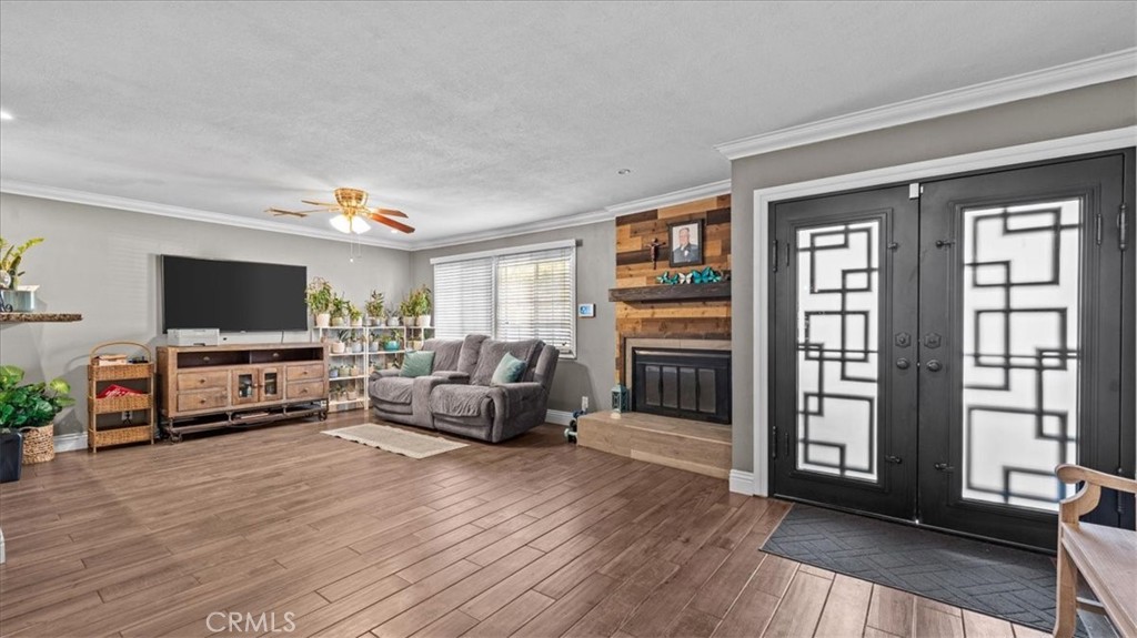8715 Lurline Street Rancho Cucamonga, CA 91701 - Photo 6 of 41 a living room with furniture and a flat screen tv
