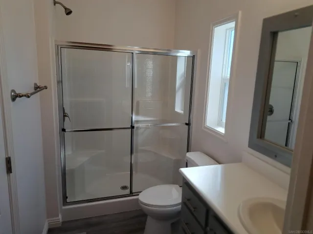 a view of walk in closet with wooden floor