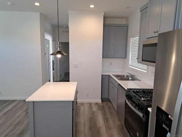 a kitchen with a stove a sink and a refrigerator