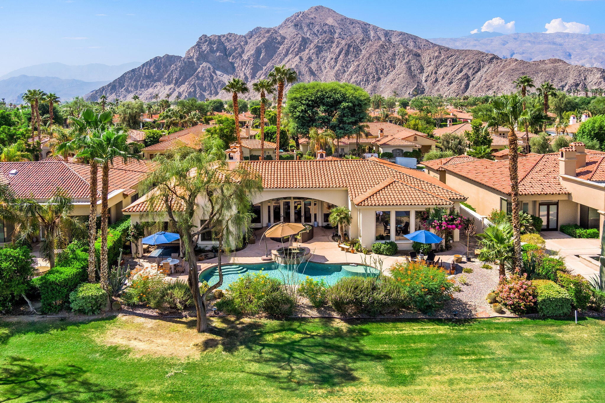79434 Cetrino La Quinta, CA 92253 - Photo 2 of 35 a front view of a house with a garden and a yard