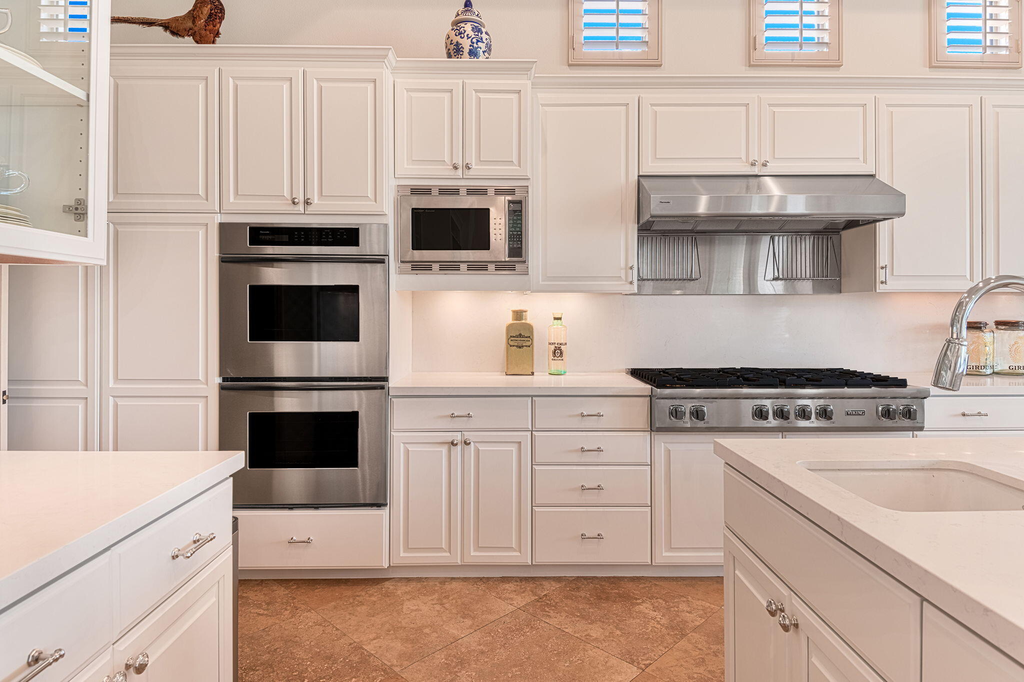 79434 Cetrino La Quinta, CA 92253 - Photo 14 of 35 a kitchen with granite countertop white cabinets and white appliances