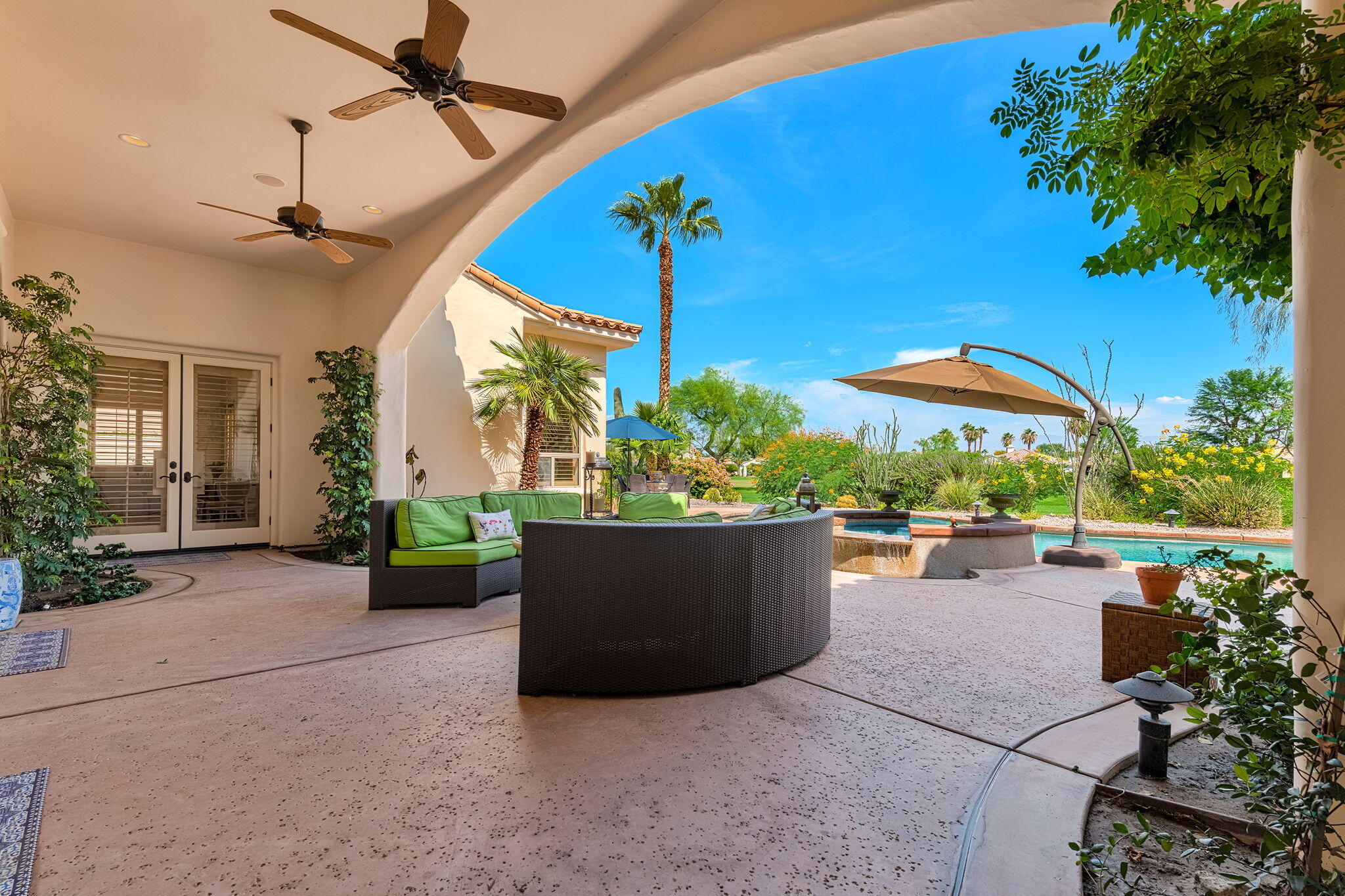 79434 Cetrino La Quinta, CA 92253 - Photo 16 of 35 a view of a patio with a table and chairs under an umbrella