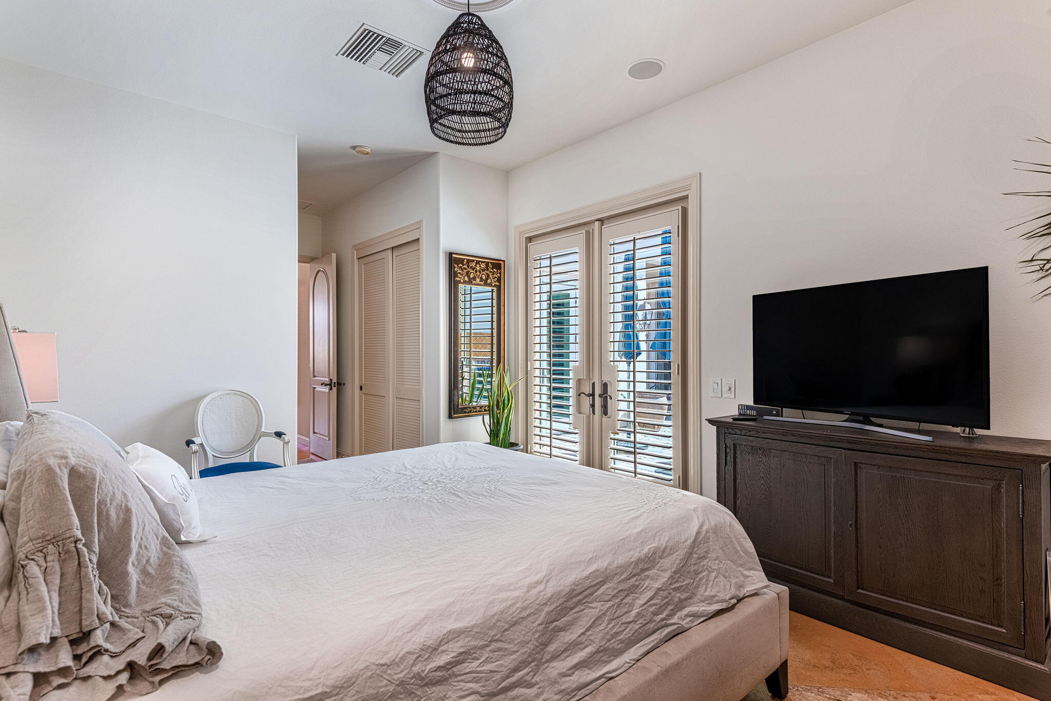 79434 Cetrino La Quinta, CA 92253 - Photo 27 of 35 a bedroom with a large bed and a flat screen tv