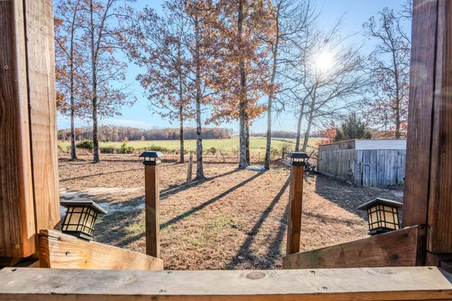 a view of a patio with dining table and chairs with wooden floor