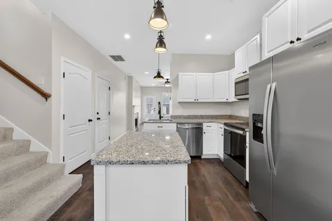 a kitchen with a refrigerator a sink and dishwasher